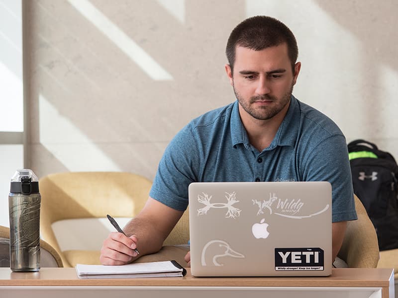 Hunter Aultman, a student in the biomedical sciences program, studies inside the School of Medicine.