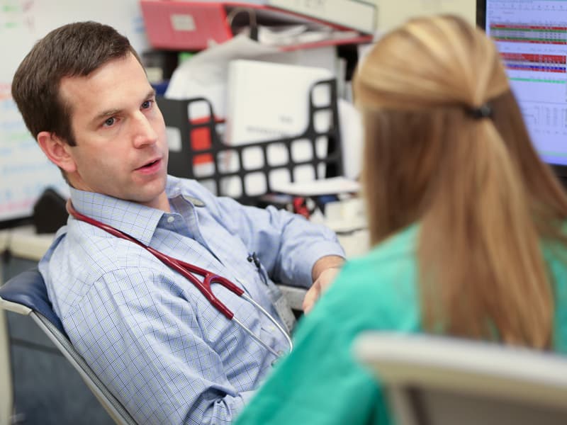 Dr. Justin Davis confers with resident Dr. Julie Waddle in the Pediatric Emergency Department.