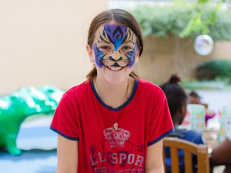 Madisyn Cockrell of Tallulah, La., shows her face paint and art work during Mississippi Children's Museum Day at Batson Children's Hospital. Her sister is a patient at the hospital.
