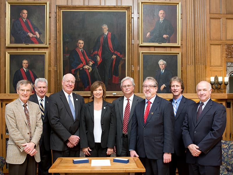 Representatives of the University of Mississippi Medical Center and the Mayo Clinic on September 30, 2014 signed an agreement to broaden and deepen their collaboration in clinical trials, other medical research, and education. Taking part in the signing were (from left) Dr. Robert Rizza, Mayo Clinic liaison for the collaboration; Dr. Dan Jones, University of Mississippi chancellor; Dr. James Keeton, UMMC vice chancellor for health affairs and dean of the School of Medicine; Dr. LouAnn Woodward, UMMC associate vice chancellor for health affairs and vice dean of the School of Medicine; Dr. Richard Summers, UMMC associate vice chancellor for research; Dr. Gregory Gores, Mayo Clinic executive dean for research; Scott Kaese, Mayo Clinic operations administrator for research; and Steven C. Smith, Mayo Clinic chairman of the Department of Research Administration.