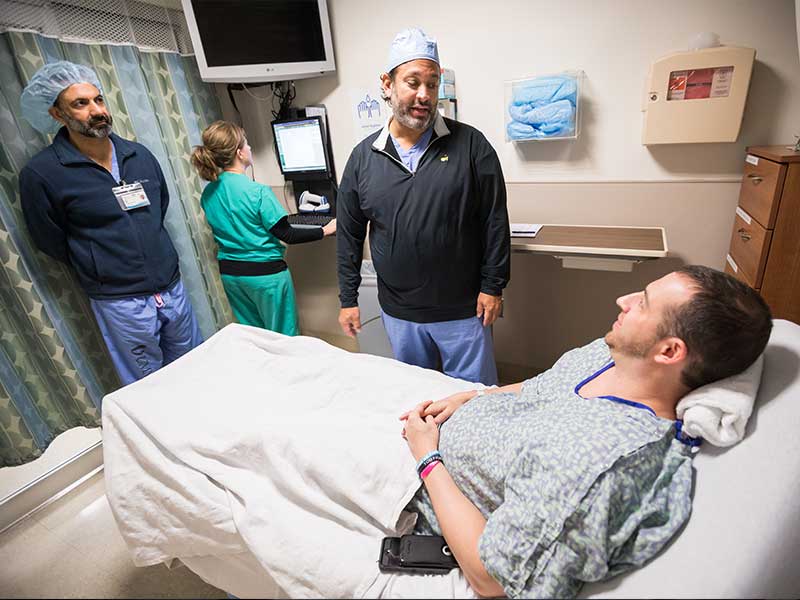 UMMC thoracic surgeon Dr. Pierre de Delva, center, chats with Sands before Sands' recent cancer surgery.