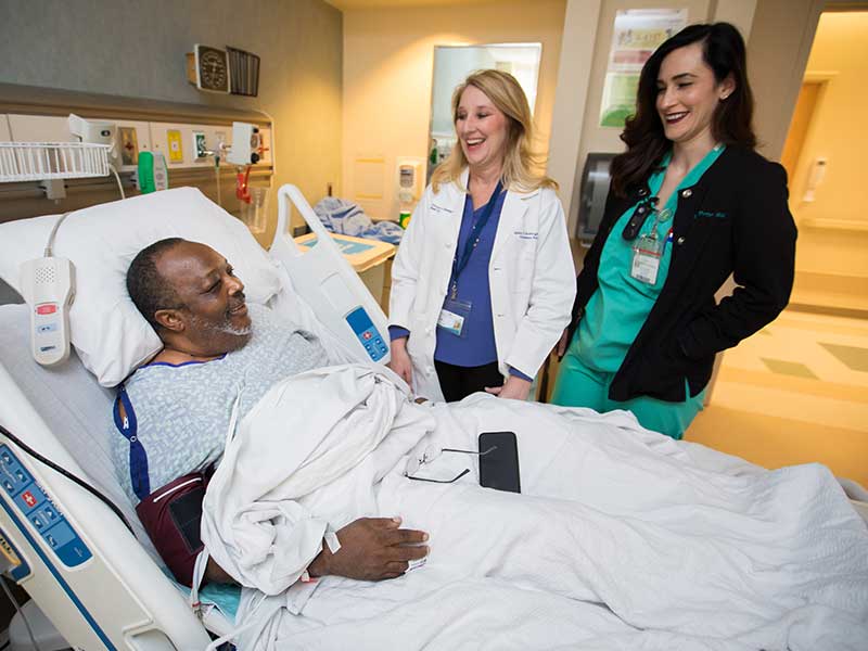 Seawright, center, and registered nurse Engaray Porter visit with transplant patient Johnny Coleman of Mobile, Ala.