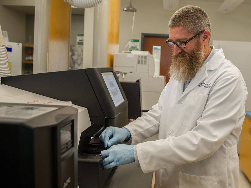 Garrett prepares to run the MGCF's MiSeq next generation sequencer.