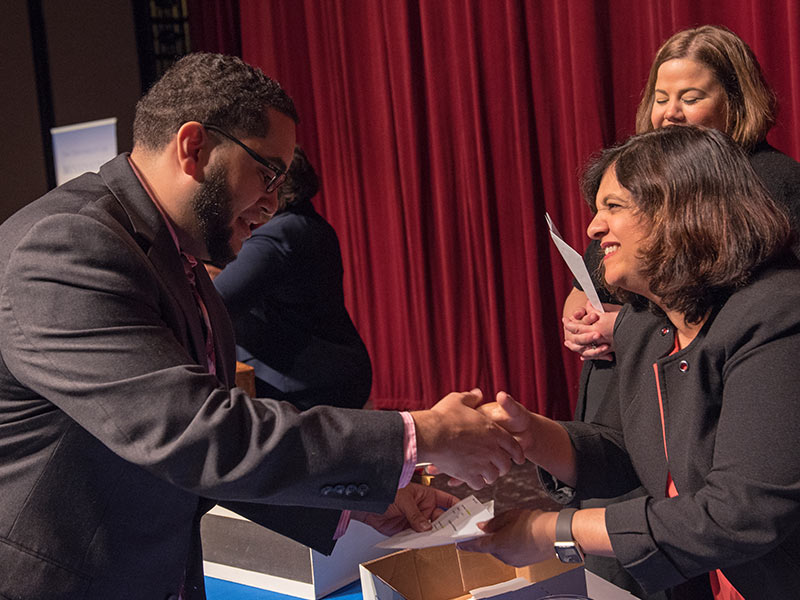 Nicholas Boullard, left, receives his match envelope from Dr. Jeni Tipnis, assistant dean for curriculum in the School of Medicine. He is headed for New Orleans to do his pediatrics residency at Tulane University School of Medicine.