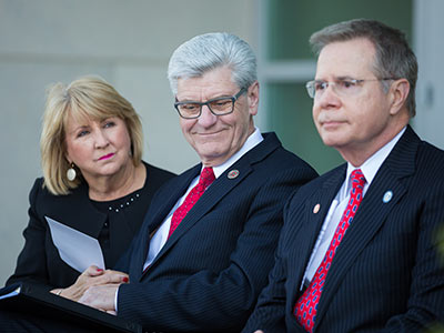 From left, First Lady Deborah Bryant, Gov. Phil Bryant and University of Mississippi Chancellor Jeffrey Vitter listen to remarks at a ceremony to formally name the Phil Bryant Medical Education Building.