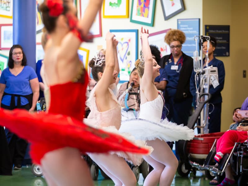 Mississippi Metropolitan Ballet dancers, from left, Mattie Grace Morris, Abigail McCaughan and Josie Nasekos demonstrate ballet positions in a learning lab at Batson.