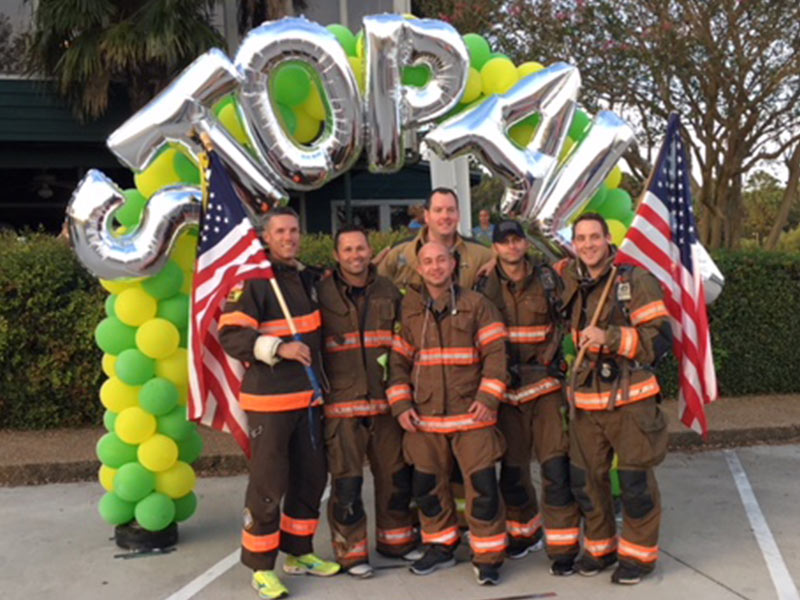 Members of the Reservoir Fire Department, including Quinton Robertson in back center, at the 2017 Brawn and Bubbles 5K.