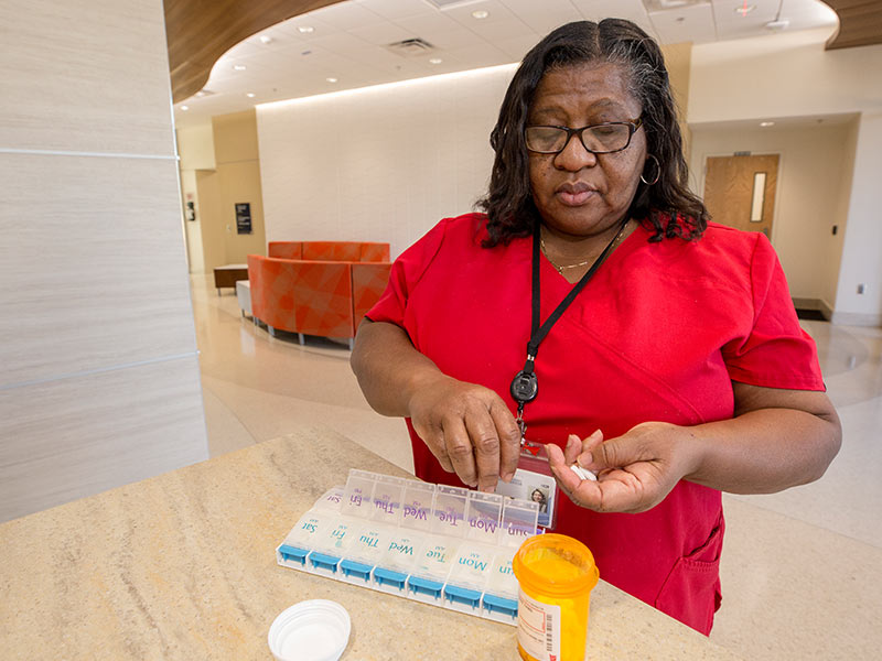 Cora Champion, a project manager at The MIND Center, has become more vigilant about taking her diabetes medications. She places them in a pill case to help ensure that she doesn't miss doses.