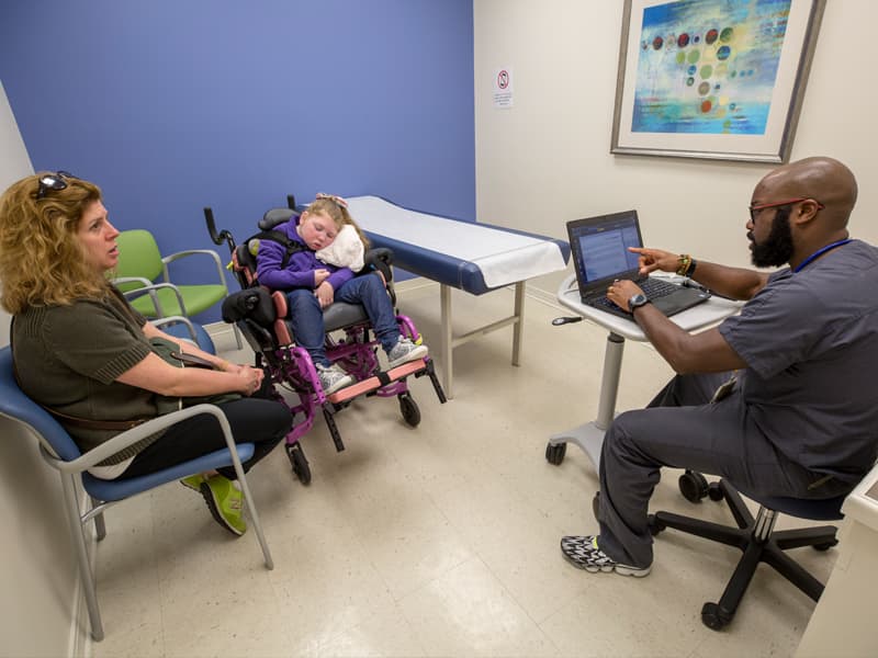 Pediatric pulmonologist Dr. David Josey talks with Angela Samples, mom of Mackenzie. The family travels to Jackson regularly to see specialists at UMMC, so having an office visit in their hometown of Hattiesburg makes care convenient.
