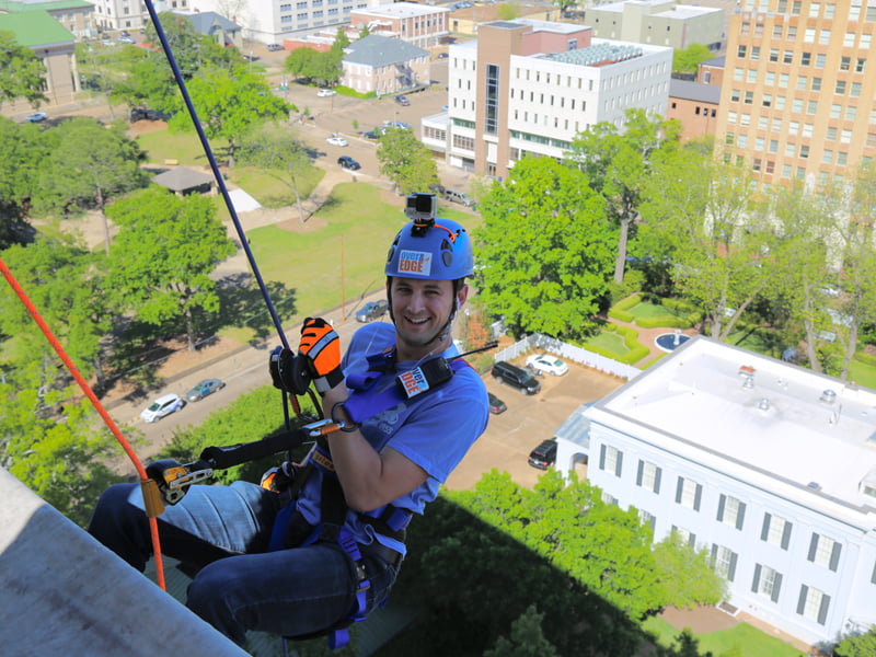 TJ Werre of WJTV heads down the Trustmark building.