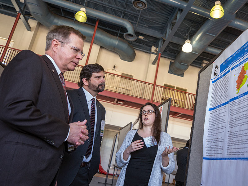 Caroline Canarios from the UM Center for Population Studies talk to UM chancellor Dr. Jeffrey Vitter and UM vice chancellor for research Dr. Josh Gladden about the Right! from the Start breastfeeding program, which includes investigators from the Oxford and Jackson campuses.