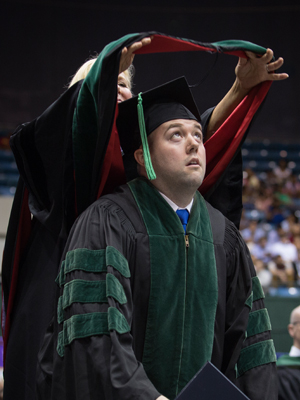 Will Crews is hooded by his mother, Dr. Karen Crews