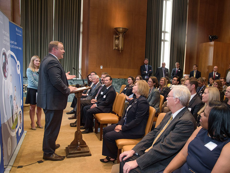 Adcock, standing at lectern, speaks at an Oct. 5, 2017 news conference in the U.S. Capitol to announce that UMMC has been named a Telehealth Center of Excellence.