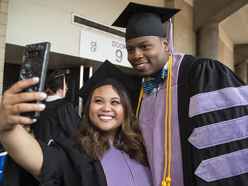 School of Dentistry graduates Maureen Malingkas, left, and Jiman Nelson take a celebratory selfie.