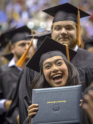 Julianne Ranis is exuberant after receiving her bachelor of science in nursing during UMMC commencement ceremonies.