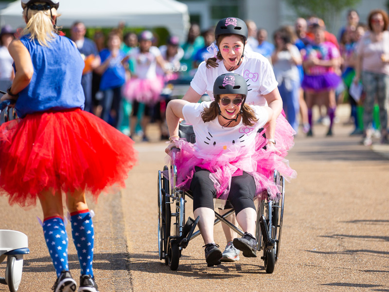 Hello Kidney team member Natalie Bradshaw pushes Lynn Thurman, both transplant coordinators, in a preliminary race.