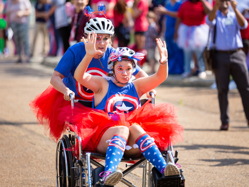 SON All-Stars and School of Nursing faculty members Dr. Josie Bidwell, sitting, and Candon Garbo, pushing.