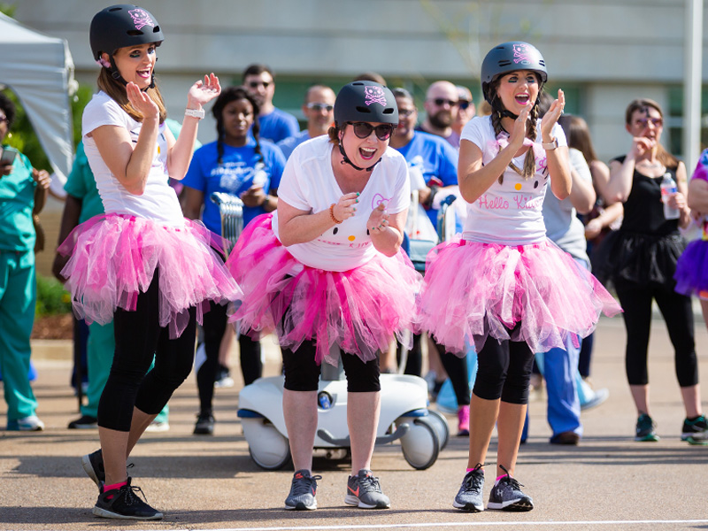 Hello Kidney team members, from the left, Jodie Kilby, Mollie King and Kristen Turnbow cheer on their team mates.