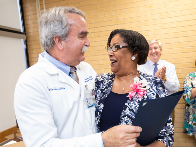 Dr. David Felton, dean of the School of Dentistry presents Agnes Triplett with a proclamation from the City of Jackson.