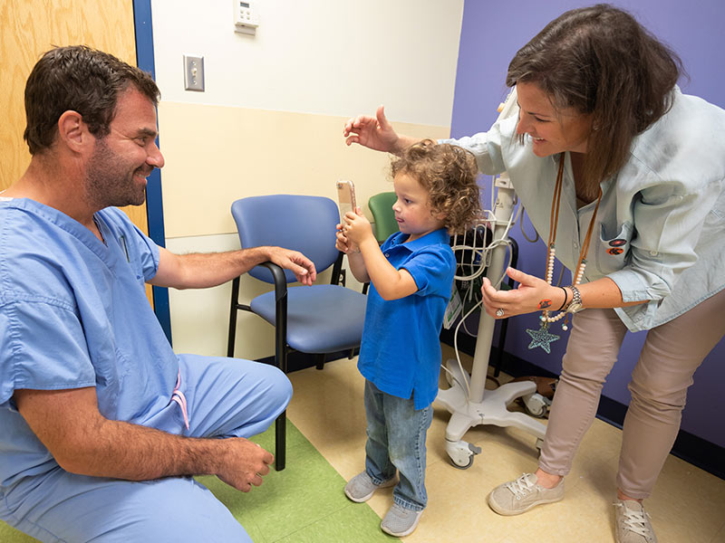 Byars picks out a "Jurassic World" sticker for his heart surgeon, Kogon, as mom Anna King looks on.