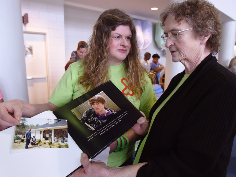 Christina Jordan and Myrtis Seat, Ian's grandmother, look through memory book of Gabriel Ian Jordan.