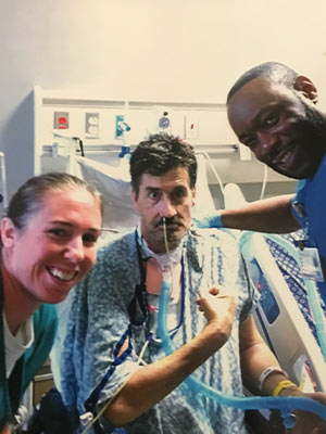 While still hospitalized, Smith is pictured with two of his UMMC caregivers, physical therapist Kirby Smith, left, and occupational therapist Marcus Harris.