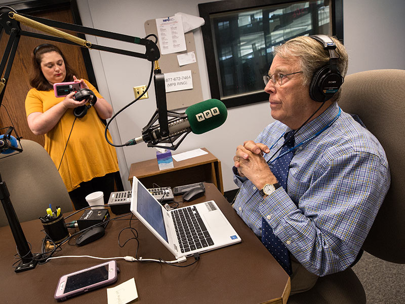 As MPB digital media strategist Ellie Banks livestreams him on Facebook, Dr. Rick deShazo records his final "Southern Remedy" radio show.