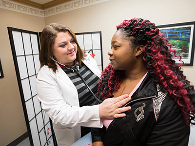 Grenada OB-GYN Dr. Amiee Watts examines Starnetia Ray.