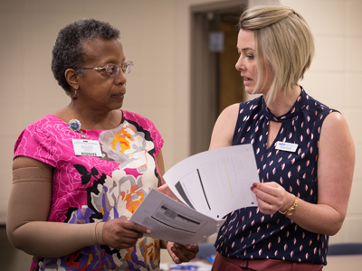 Porritt discusses training methods with Karen Winters, professor of nursing.