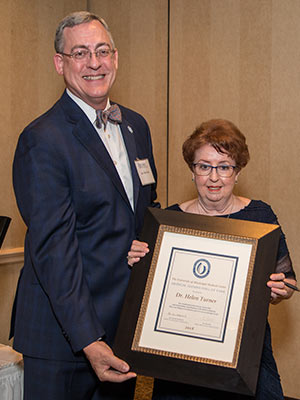 Dr. Helen Turner, right, associate vice chancellor emeritus, is one of five Hall of Fame inductees who were presented with framed certificates by Dr. Tim Folse, outgoing Medical alumni Chapter president.