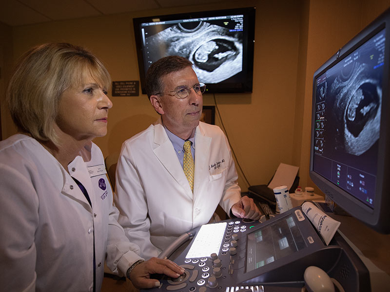 Dr. Marty Tucker, the 2018 Distinguished Medical Alumnus Award honoree, reviews a diagnostic image with with Jan Boykin, sonographer, at his Jackson Healthcare for Women clinic.