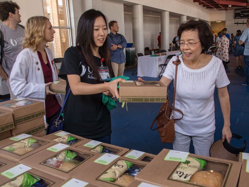 First-year medical student Aram Seo, left, serves her mother Yoon Seo during Family Day lunch in the Student Union Gym.