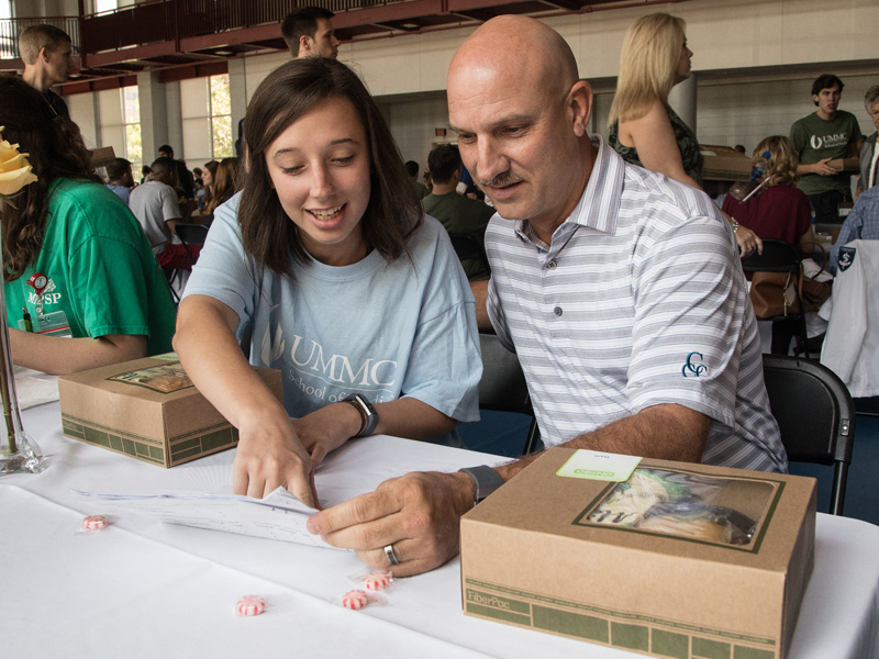 First-year medical student Maggie Dickerson, left, reviews a schedule of afternoon events with her father Guy.