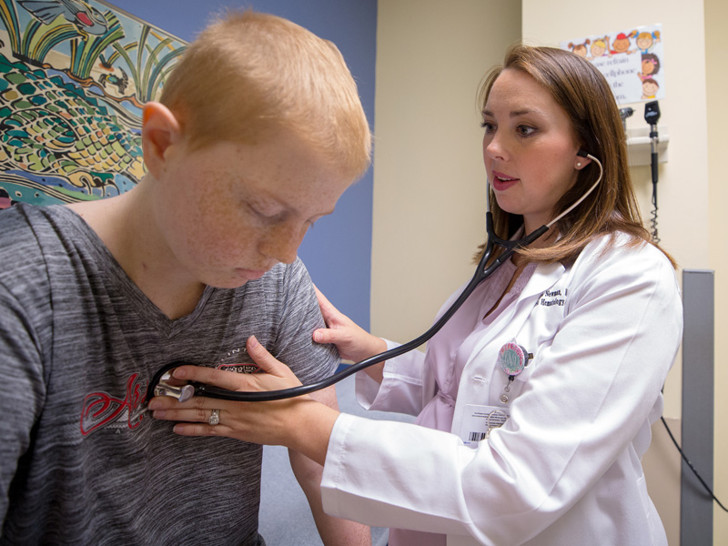 Newman listens to the heartbeat of Children's of Mississippi patient Olivia Newman of Clinton.