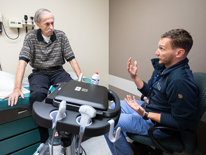 Jackson resident Wayne Simpson listens to Senitko explain results of Simpson's medical thoracoscopy procedure.