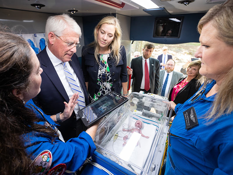 Wicker and Kristy Simms of UMMC Government Affairs learn about a specialized intensive care isolette from transport nurse practitioner Casey Hall, left, and transport registered nurse April Davidson, right. The Mississippi Center for Emergency Services' deployable vehicles includes critical care transport for newborns.