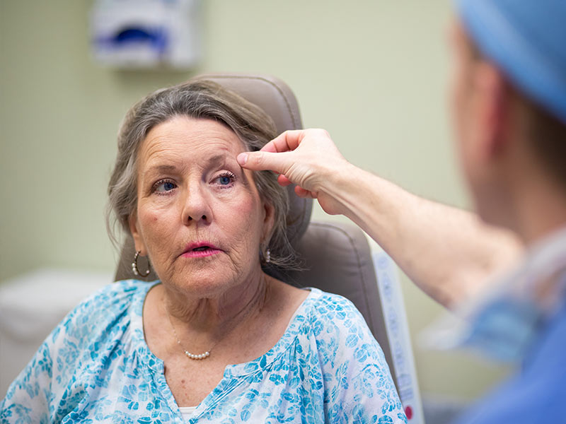 Black looks at the small scar left from patient Puckett's Mohs surgery. 