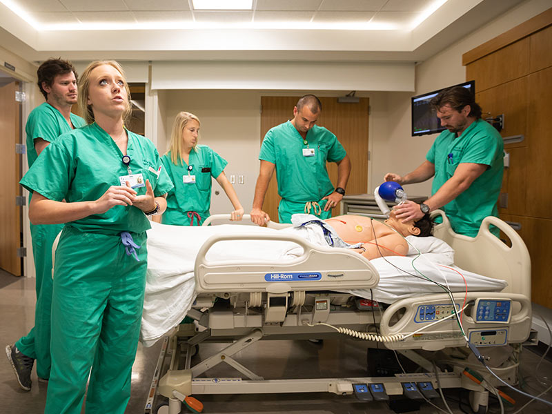 During one of several simulated emergency cases, Dr. Erin Walker, foreground, leads a team of her fellow Emergency Medicine residents: from left, Dr. Macon Morris, Dr. Paige Bell, Dr. Joshua Rouhan and Dr. Harold Gage.