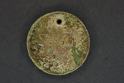 Well-worn penny called a spirit coin with a hole in it.