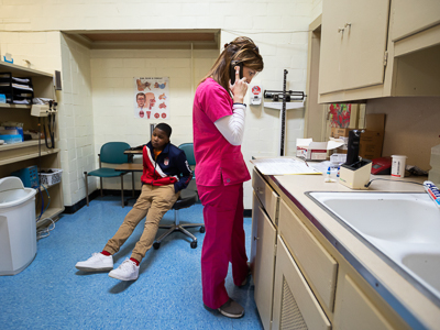 South Delta Middle School student Albert Russell waits as Gwen Dew calls his grandmother to tell her Russell tested positive for strep throat.