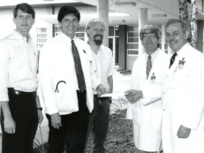 In this undated photo, Arceneaux, second from right, participates in a presentation near the original School of Medicine entrance. Among those present are the late Dr. Carl G. Evers, far right, professor of pathology and associate dean for Academic Affairs.