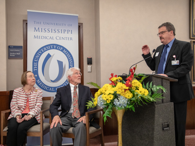 With Dr. Jean Arceneaux and Dr. Lincoln Arceneaux looking on, Dr. Jerry Clark, chief student affairs officer and associate dean for student affairs, describes the fondness for "all things south Louisiana, which he and his predecessor share.