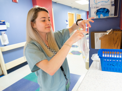 Makenzie Rowzee, a registered nurse on 3 Children's, prepares a sample to be sent to the laboratory for analysis.