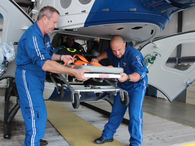 AirCare2 flight registered nurse Todd Perry, left, and flight paramedic Ben White unload a gurney from the helicopter at the Meridian base. Bill Graham/The Meridian Star