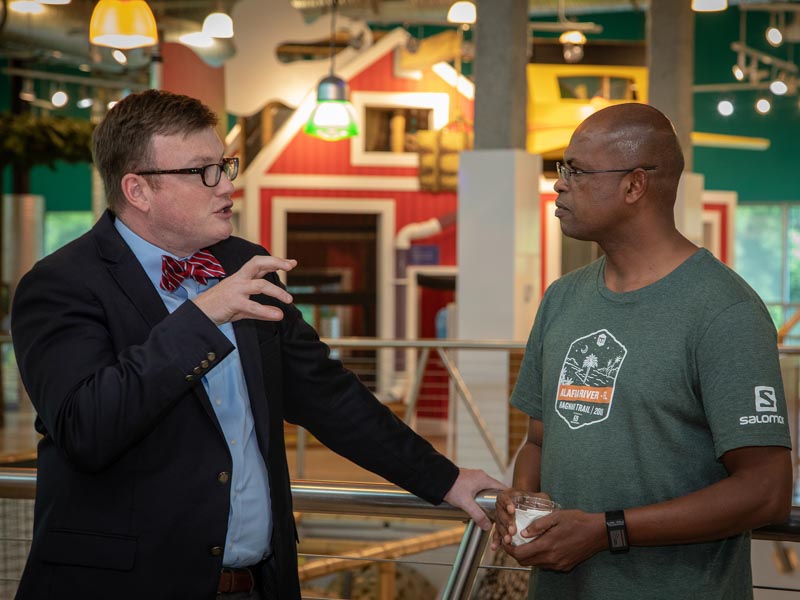 Dr. Brad Ingram, associate professor of pediatric neurology and assistant dean of graduate medical education, chats with new resident Dr. Naser Mohammedelamien during a welcome party.