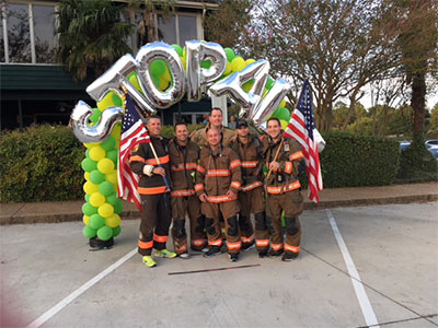 Members of the Reservoir Fire Department, including Quinton Robertson, back row center, are all smiles at the 2017 Brawn and Bubbles 5K benefiting The MIND Center. Robertson had the idea to create a Mississippi car tag supporting Alzheimer's after the death of his father from the disease.