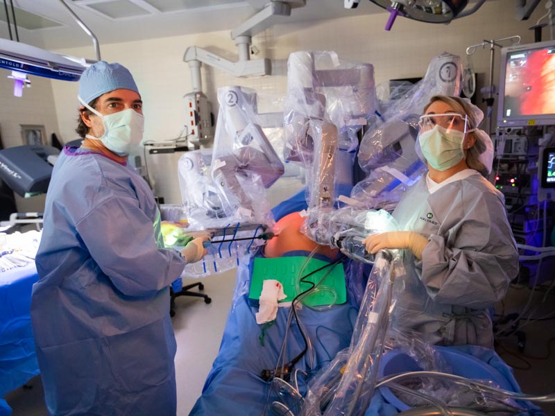 Dr. Mark Earl and surgery resident Dr. Taylor Shaw work together on a robotic procedure to remove a patient's pancreatic cancer.