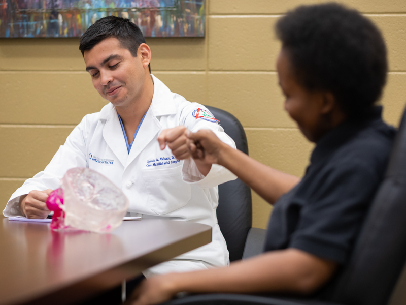 Dr. Ignacio Velasco Martinez and patient Violet Thompson share a fist bump.