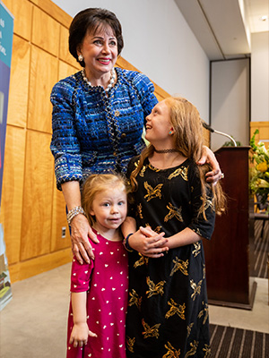Children's of Mississippi patient Avery Bell, right, and her little sister, Milly Jean, enjoy meeting Gayle Benson.