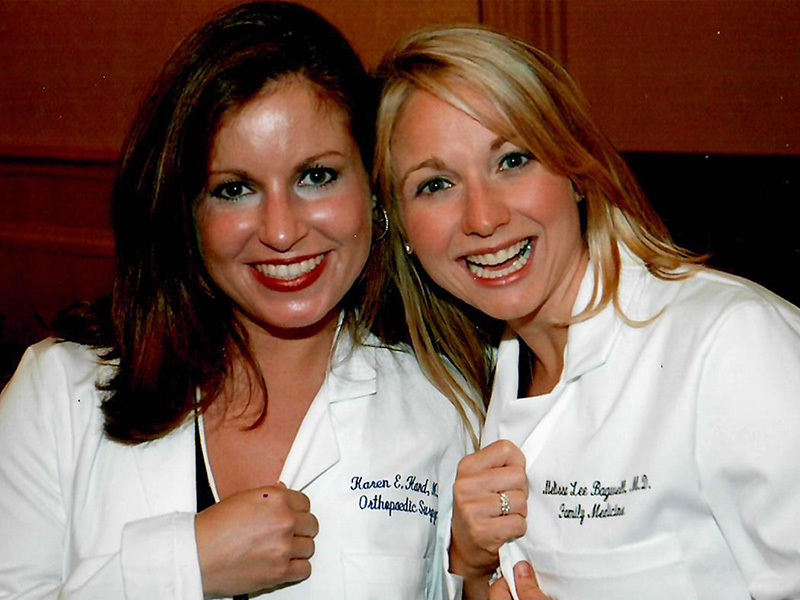 Hand, left, and Dr. Melissa Bagwell Love celebrate getting their long white coats before their 2006 graduation from the School of Medicine. 
